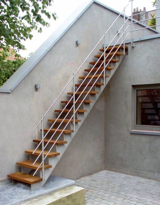 a set of stairs leading up to the top floor of a house with glass doors