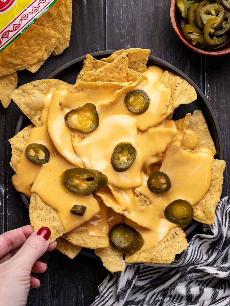 nacho cheese sauce on a plate with pickles