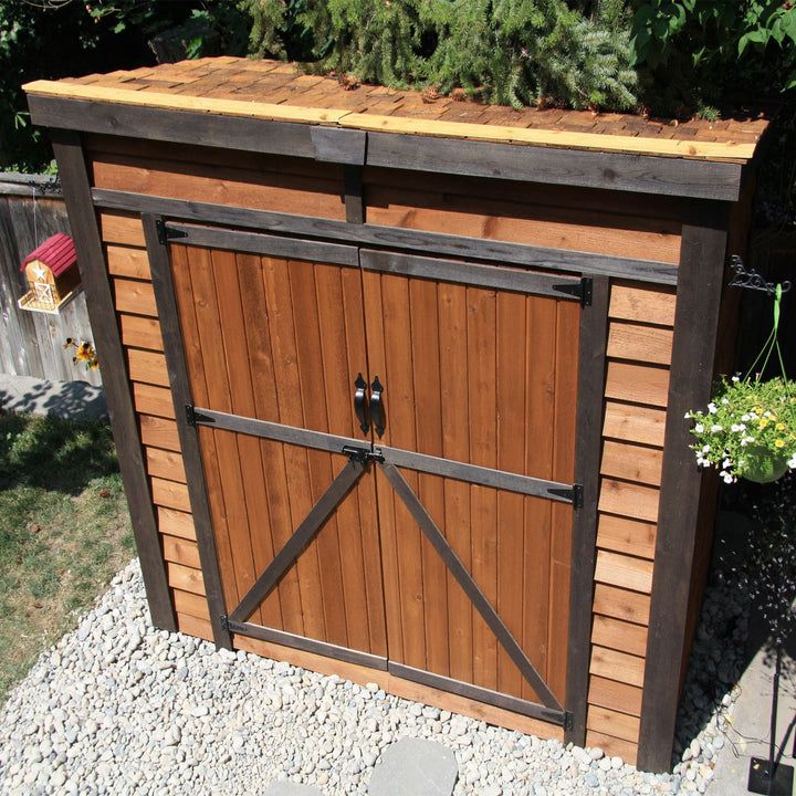 an outdoor storage shed with the doors open