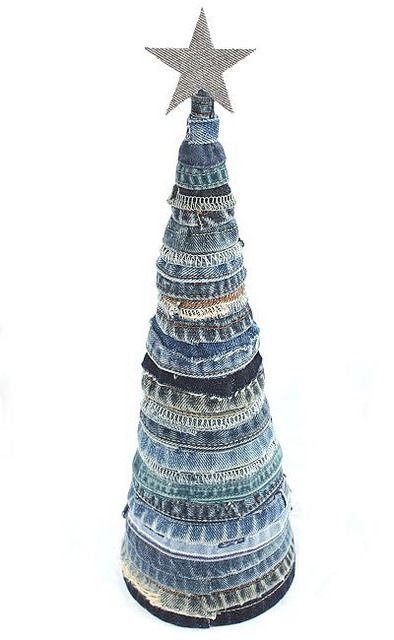 a christmas tree made out of old jeans with a star on top, sitting in front of a white background