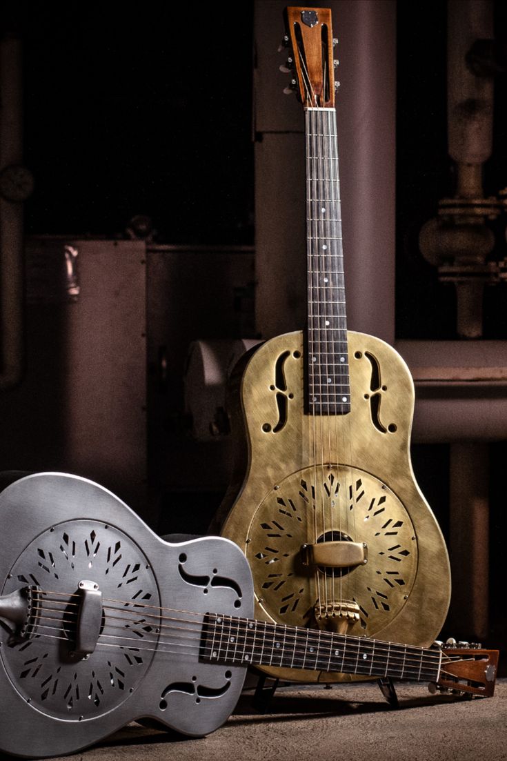 two guitars are sitting next to each other