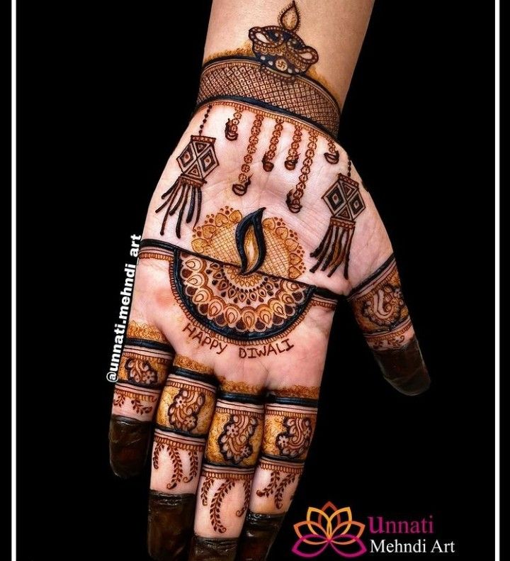 a hand with henna and jewelry on it