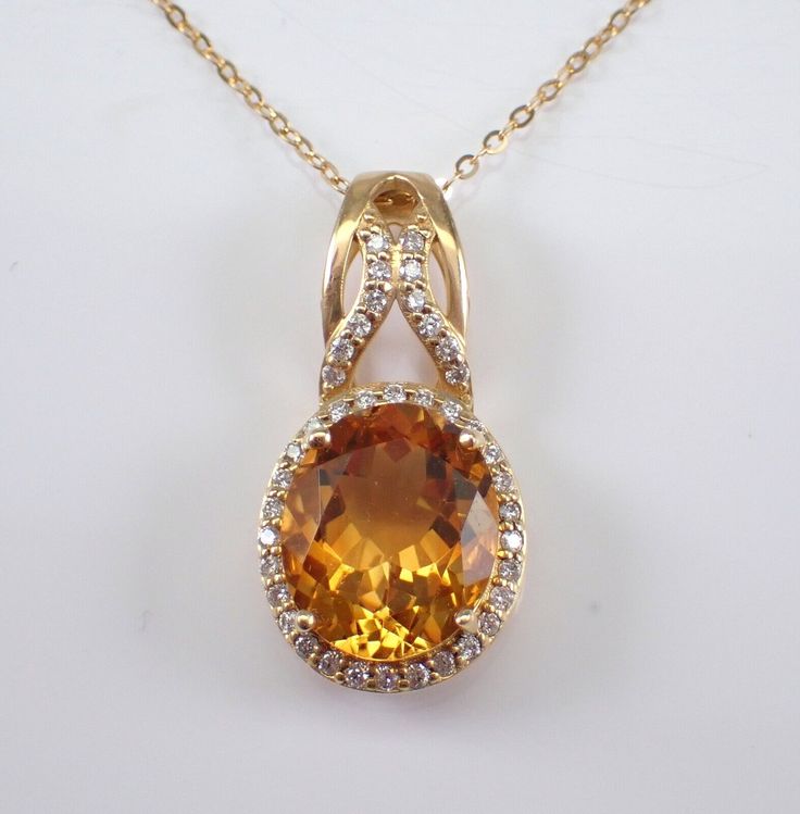 14K Yellow Gold Diamond and Citrine Necklace with Chain. This necklace is set with an Oval Citrine and forty natural Round Brilliant Diamonds.  The Citrine measures 12 x 10 mm. The diamonds in this pendant are H color, SI/I1 clarity.  The pendant is 14K Yellow Gold and comes with an 18" 14K Yellow Gold chain and together weigh 4.1 grams. The pendant measures 26 X 13 mm. This necklace will be accompanied by an appraisal written by a GIA Certified Diamond Grader with the retail replacement value of $1,789.00. I will ship this necklace promptly in a beautiful gift box. Oval Gold Gemstones With Accents, Luxury Amber Oval Necklace, Luxury Oval Stone Necklaces, Luxury Oval Necklaces With Stones, Orange Oval Cabochon Jewelry For Formal Occasions, Formal Oval Amber Necklace, Formal Orange Oval Cabochon Jewelry, Gold Citrine Jewelry In Oval Cabochon Shape, Gold Oval Gemstones With Accent Stones