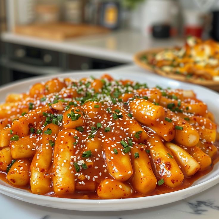 a white plate topped with pasta covered in sauce