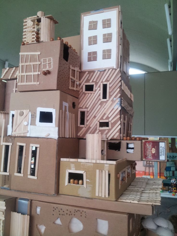 cardboard houses are stacked on top of each other