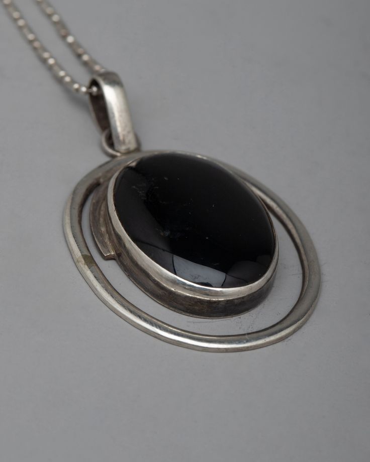 Black Onyx Locket Disclaimer: Please note that the locket you've ordered does not include the chain/necklace. However, we have some special chain/necklace available to complement your locket perfectly. If you're interested in our chain/necklace options, please don't hesitate to send us a message for more details. Thank you for choosing us!About our locket Introducing our gorgeous Black Onyx Locket, which is carefully made of sterling silver and has an oval-shaped black onyx stone inlaid beautifu Black Jewelry With Large Round Pendant, Black Round Pendant Necklace, Formal Black Locket Necklace, Black Oval Jewelry With Large Pendant, Black Medallion Locket Necklace, Classic Black Medallion Jewelry, Black Hallmarked Round Pendant Necklace, Black Hallmarked Round Necklaces, Black Medallion With Large Pendant