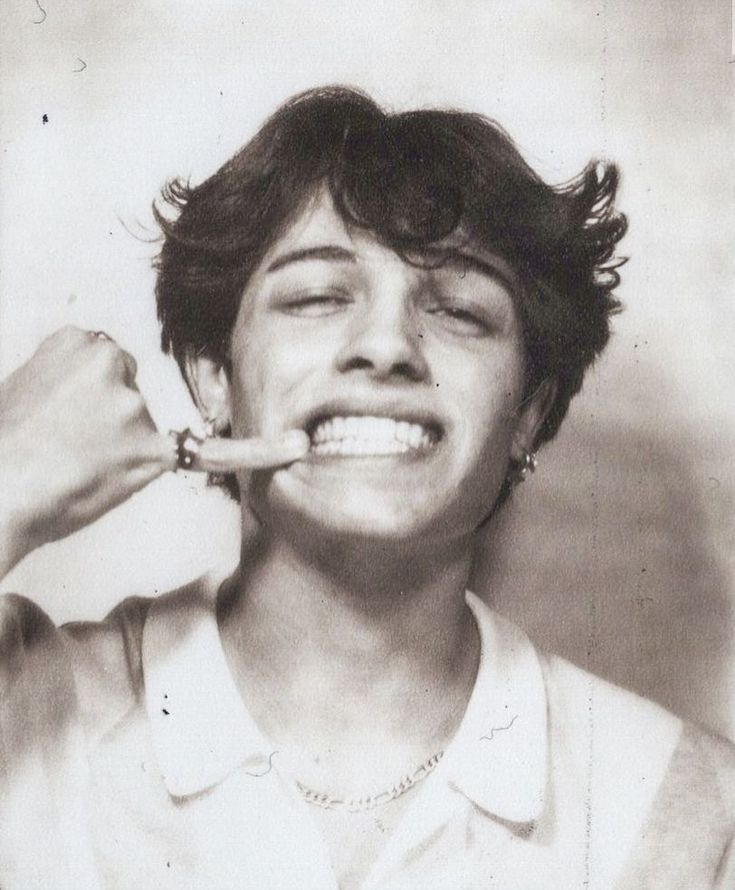 an old black and white photo of a woman brushing her teeth with a toothbrush