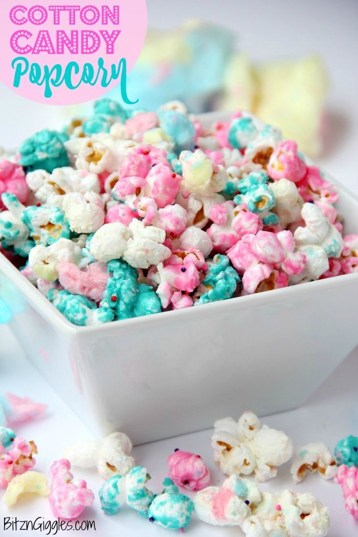 cotton candy popcorn in a white bowl with pink and blue sprinkles