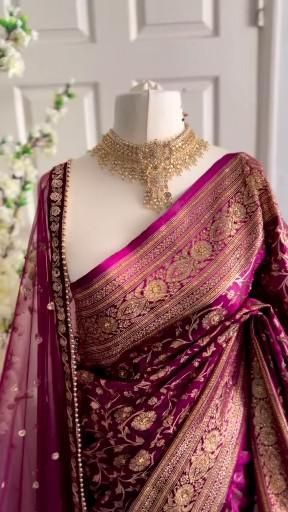 a mannequin wearing a purple and gold sari with jewelry on it's neck