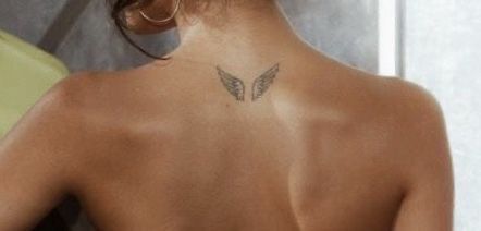 a woman with a butterfly tattoo on her back