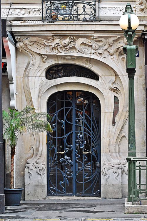 the entrance to an old building with wrought iron doors