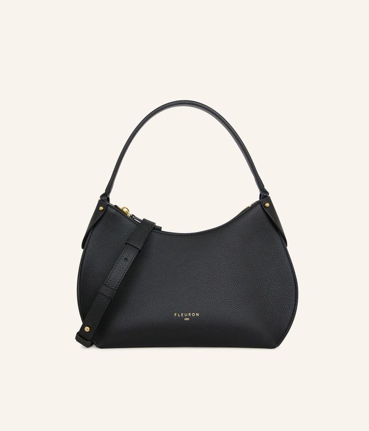 Black, a timeless color and always an excellent choice for effortless morning style.
Our black handbag is carefully handcrafted in our workshops in Italy, using the finest grained calf leather, complemented by refined gold finishes. Whether carried by hand or on the shoulder with its additional strap, this bag is a perfect complement to any look. Its secure zipper opens to a beige interior, offering ample and elegant space for your essentials. Timeless Textured Leather Shoulder Bag For Office, Timeless Shoulder Bag With Adjustable Strap, Classic Top Handle Hobo Bag For Office, Timeless Saffiano Leather Shoulder Bag With Gold-tone Hardware, Timeless Hobo Bag With Gold-tone Hardware For Office, Timeless Black Shoulder Bag With Round Handle, Timeless Formal Hobo Bag With Detachable Strap, Timeless Evening Shoulder Bag In Textured Leather, Timeless Satchel With Gold-tone Hardware And Saffiano Leather