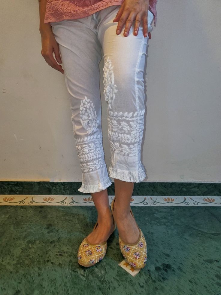 Soft Pure cotton Slim Pants with tassel trims and embroidered in chikankari. Side Pockets. Length - S - 37 inches M - 37 inches L - 38 inches XL - 38 inches XXL - 39 inches Size - S - waist stretched fits upto 40 M - waist stretched fits upto 42 L - waist stretched fits upto 44 XL - waist stretched fits upto 46 XXL - waist stretched fits upto 48/50 White Traditional Sets With Tassels, Traditional White Sets With Tassels, Festive Pants With Embroidered Border For Spring, Traditional Embroidered Ankle-length Bottoms, Traditional Floral Embroidery Pants For Festive Occasion, Traditional Floral Embroidered Pants For Festive Occasion, Traditional Floral Embroidered Festive Pants, Spring Straight Pants With Resham Embroidery, Straight Pants With Resham Embroidery For Spring