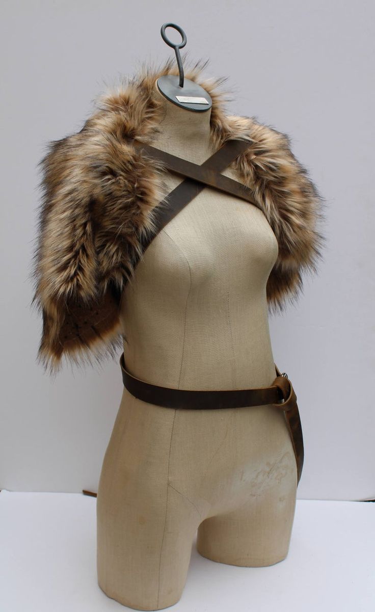 a mannequin wearing a fur collar and harness