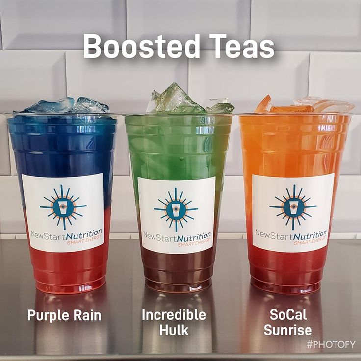 three different colored drinks sitting on top of a counter