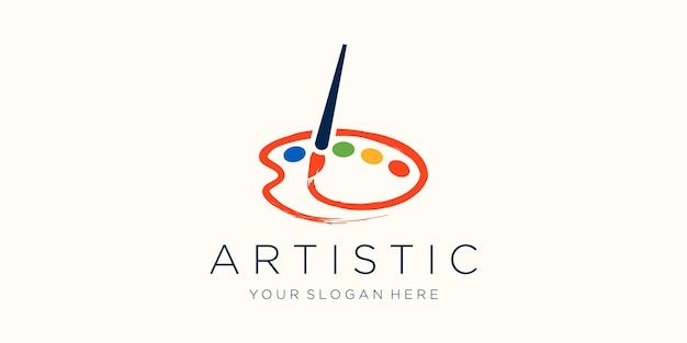 an artistic logo with paintbrushes and dots on the bottom, as well as a circle