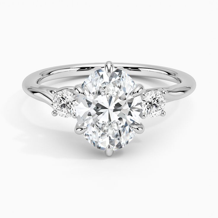 an oval cut engagement ring with side stones