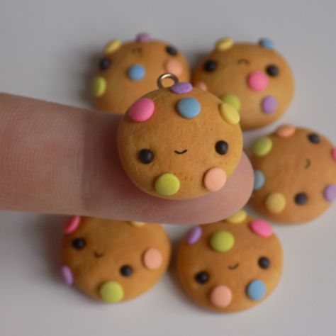 a person's finger with some cookies on it