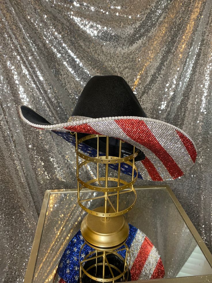 The “America” hat is perfect for your summer on the lake, BBQs, Labor day weekend, rodeos, and any events you may be attending! This hat will feature the American Flag print on the bottom. Choose whether you want crystal rhinestones on the top brim as well, or leave it plain with the crystal hat band that comes with it! **Please note - due to the bright colors on the American flag hat, they can fade over time, especially if they are exposed to rain or water** This hat features: Black straw hat U Crystal Hat, America Hat, Black Straw Hat, American Flag Hat, Flag Hat, The American Flag, Labour Day Weekend, American Flag Print, Labor Day Weekend