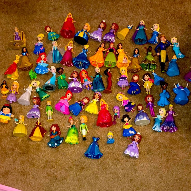 there are many princess figurines on the floor