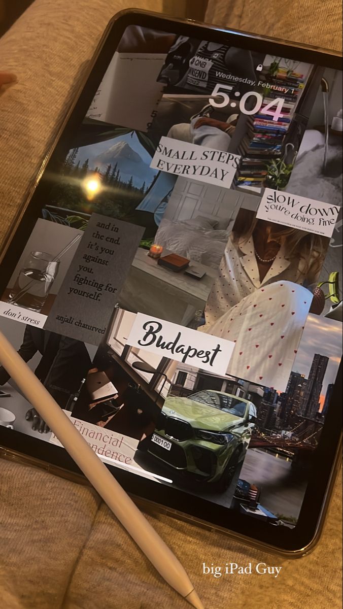 a tablet with magazines on it and a pen laying next to it in front of the screen