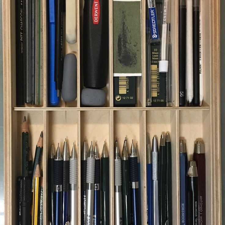 a wooden box filled with lots of different types of pens and pencils