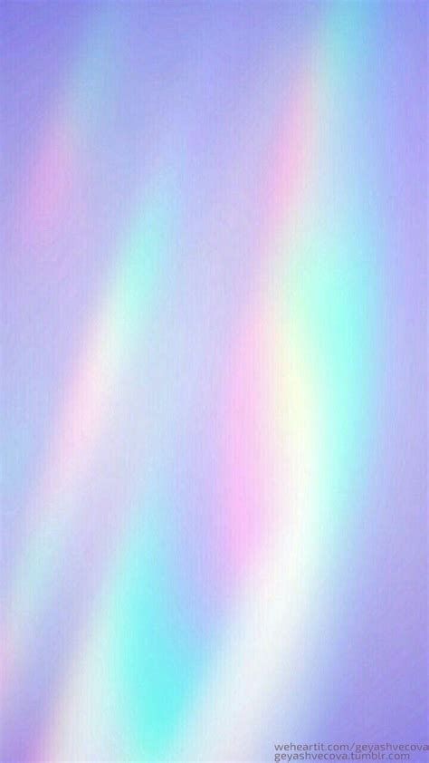 a blurry image of rainbow colors in the sky with white and blue highlights on it