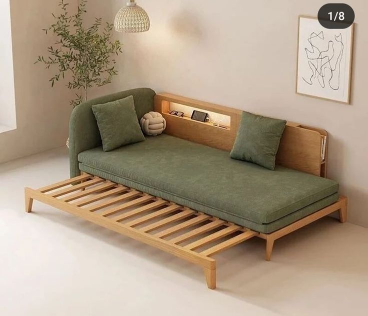 a couch that is sitting in the middle of a room with a book shelf underneath it