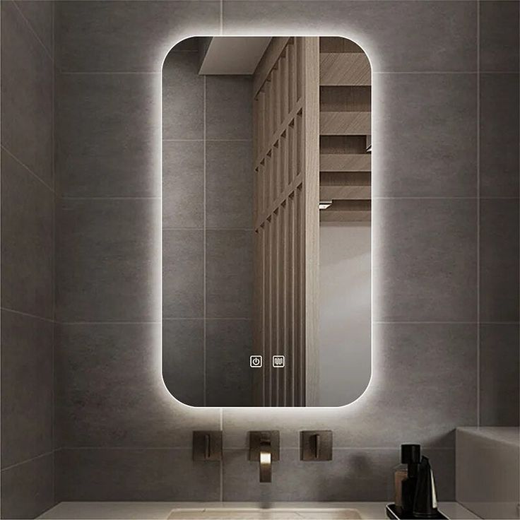 a bathroom with a sink, mirror and light on the wall above it's counter