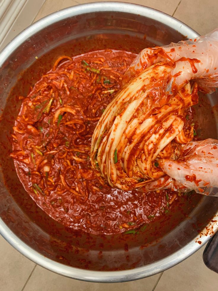 someone is stirring some food in a large pot