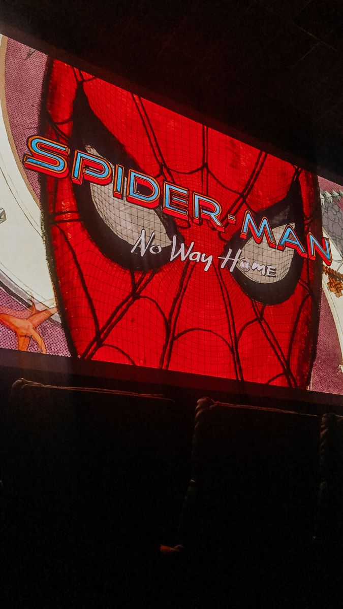 the spider man logo is projected on a large screen