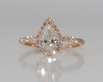 an engagement ring with a pear shaped diamond