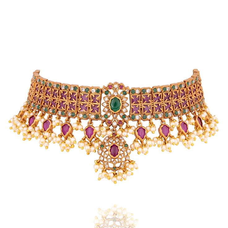 Where tradition meets magnificence, a timeless masterpiece of opulence! Step into a world of regal splendor with this exquisite set, a harmonious blend of tradition and modern grandeur. This captivating ensemble features a meticulously crafted set adorned with a lattice of ruby and dazzling emerald stones, encircled by radiant kundan stones, exuding an aura of unparalleled elegance. The set includes a necklace and a pair of matching earrings. Approximate earrings length is 1.2". Gold-plated on h Elegant Ceremonial Sets For Diwali, Classic Gold Sets For Festive Season, Classic Gold Festive Sets, Classic Gold Festive Set, Elegant Kundan Sets With Intricate Design, Elegant Festive Sets With Intricate Design, Elegant Kundan Sets For Ceremonial Occasions, Elegant Red Sets For Ceremonial Occasions, Elegant Kundan Formal Sets