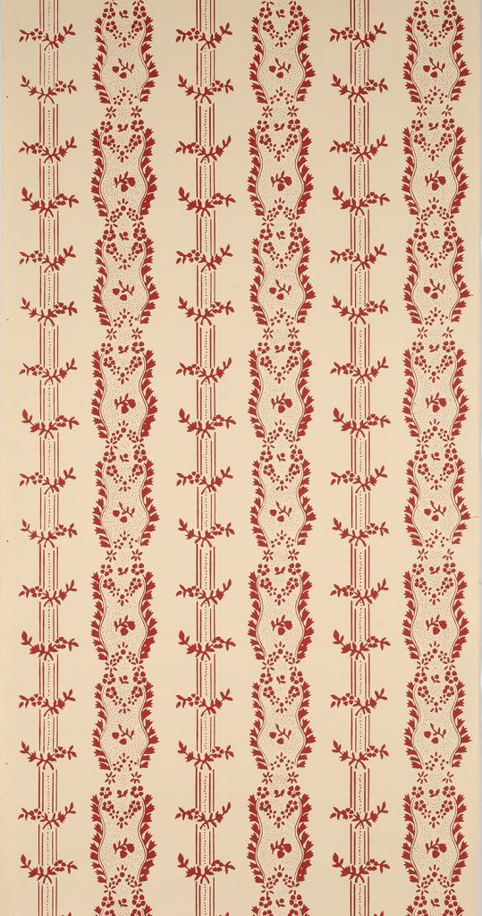 a red and white rug with vines on it