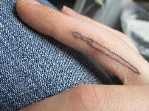 a person's finger with a tattoo on it