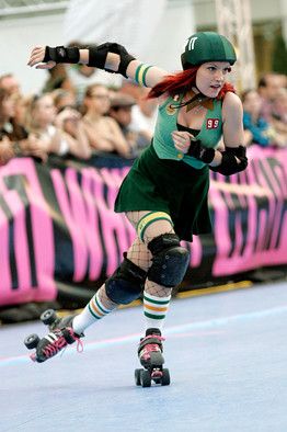 a woman rollerblading in front of a crowd