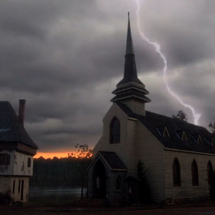 a church with a lightning bolt in the background