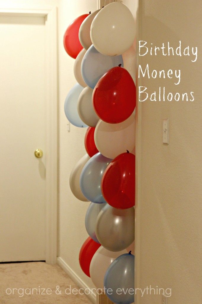 a bunch of balloons are hanging from the wall in front of a door that says birthday money balloons