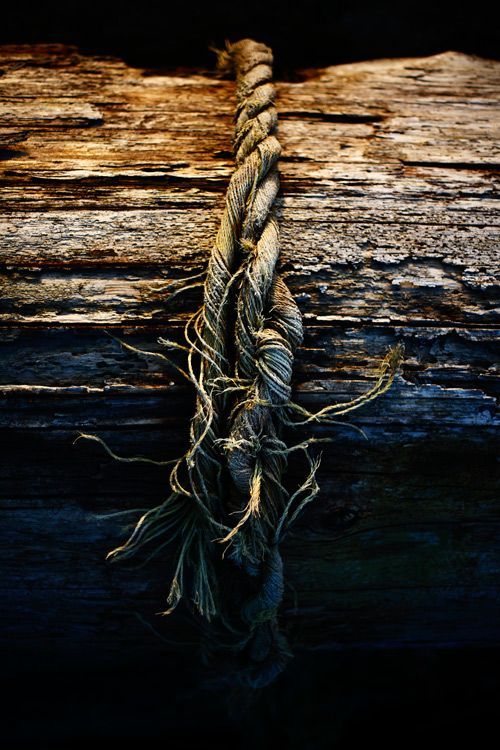 a rope is hanging from the side of a wooden structure