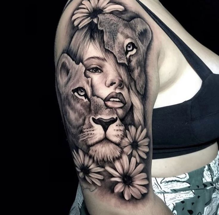 a woman's arm with a lion and flowers tattoo on her left shoulder,