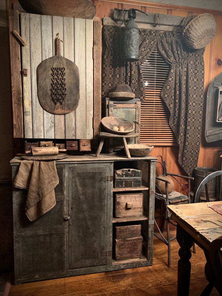 an old fashioned kitchen with wooden cabinets and drawers