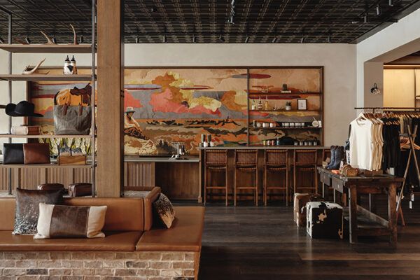 a living room filled with furniture and lots of wood flooring next to a wall