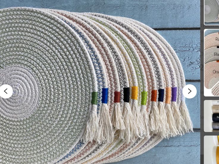 a wall hanging made out of woven material with colorful tassels on the ends