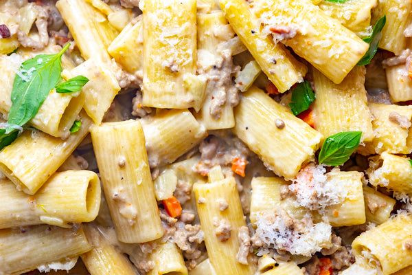 pasta with meat, cheese and parmesan on a plate