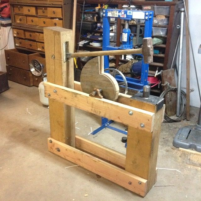 a machine that is sitting in the middle of a workbench with tools on it