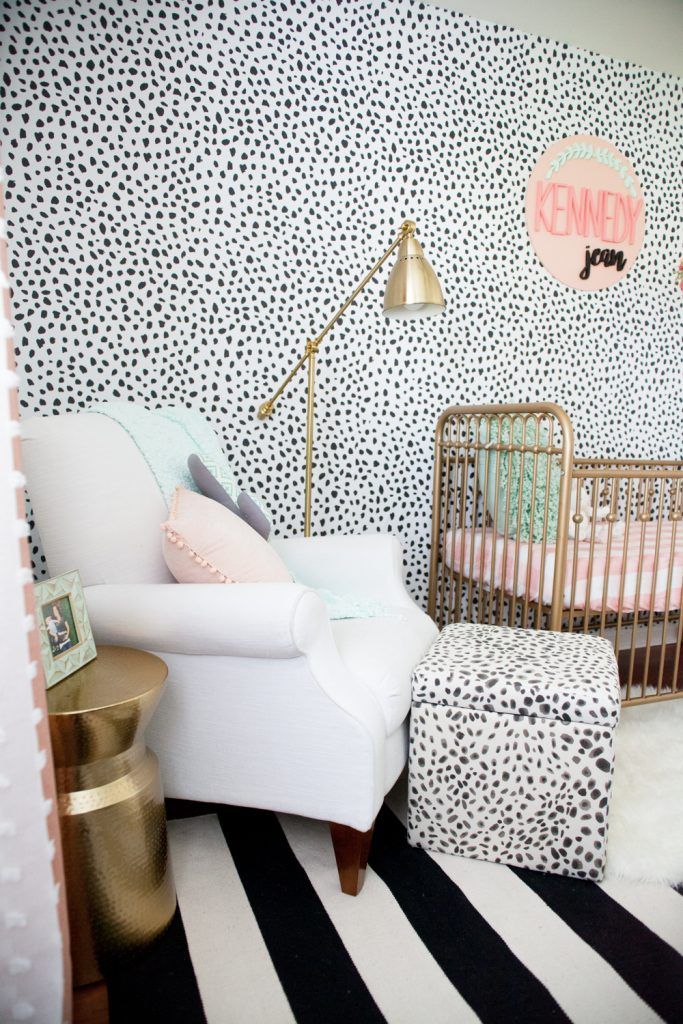 a baby's room with black and white wallpaper, gold accents and a leopard print crib