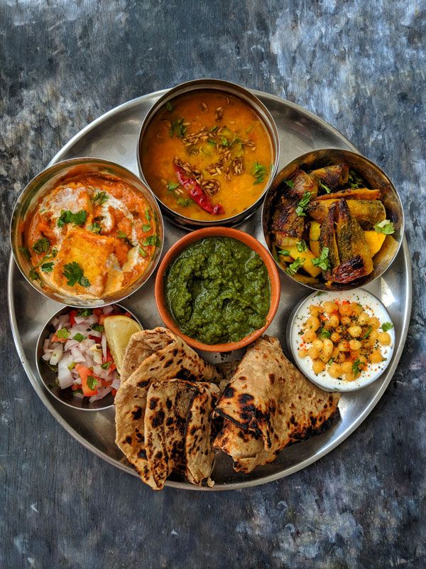 a metal plate topped with different types of food