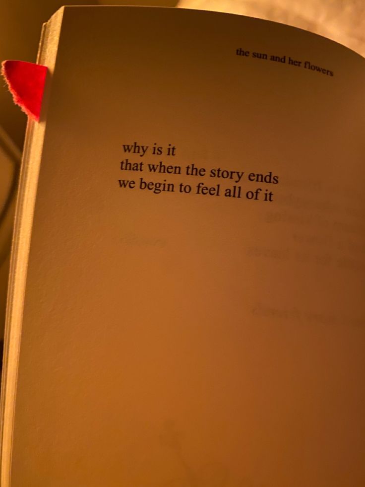 an open book with a red heart on the page and a quote written in it