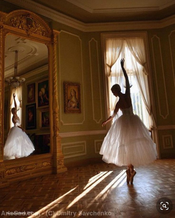 a woman in a white dress is dancing