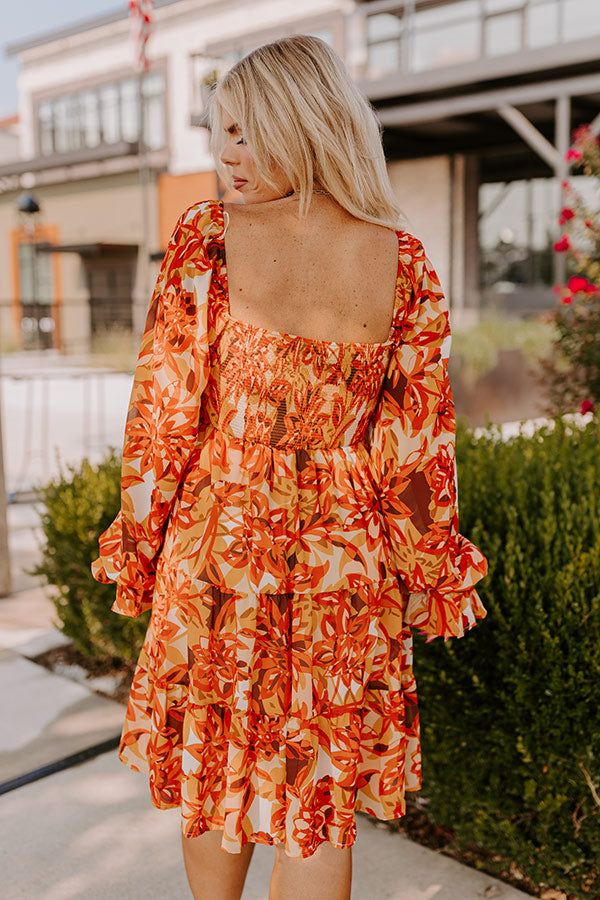 - With all the vibrant colors of autumn, this trendy dress will have you ready for cooler days. It pairs perfectly with your favorite boots and a wide brimmed hat for a stylish look. You are sure to fall for this cutie! - Breezy chiffon material with an abstract floral print featuring brown, cream, yellows, and orange hues - A built-in skirt lining - A v-cut neckline - Long sleeves with elastic rifle cuffs - A smocked bodice - A flowy yet flattering silhouette that ends in a ruffled mini dress l Wide Brimmed Hat, Smocked Mini Dress, Ruffled Mini Dress, Colors Of Autumn, Skirt Lining, Concert Fashion, Orange Hues, Brimmed Hat, Essential Dress